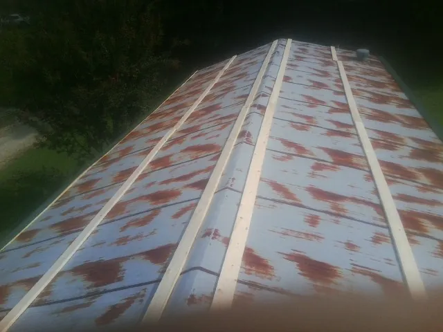 Rusted metal roof panels with new wood purlins before replacement — Storm Damage Roof Repair in Poplar Branch by Roofing Brothers